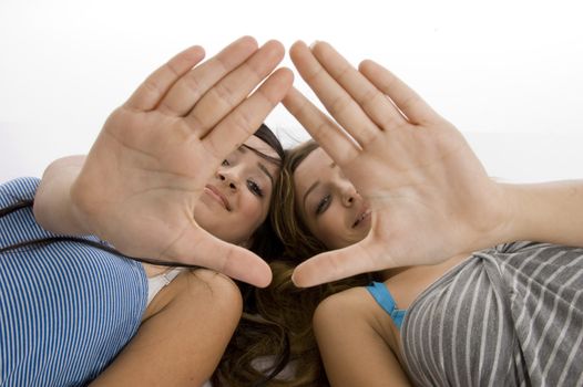 laying girls showing hand gesture on  an isolated white background 