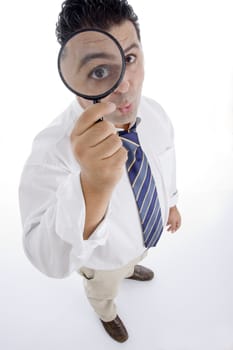 standing businessman looking through lens on  an isolated white background 