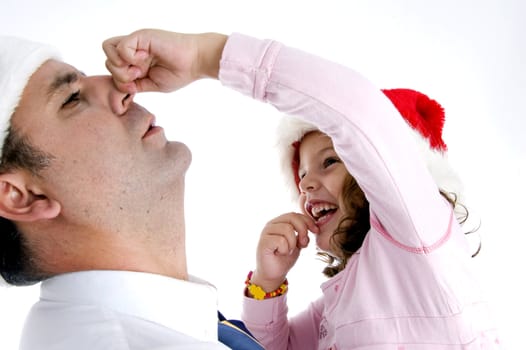 little girl holding her father's nose