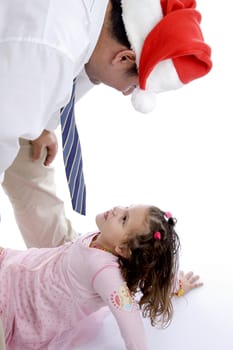 father wearing christmas hat playing with his little daughter