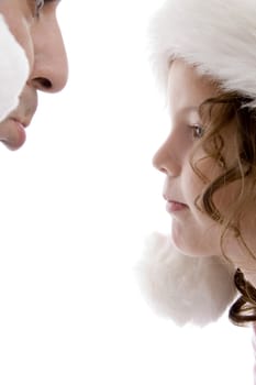 close up of father and little girl wearing christmas hat