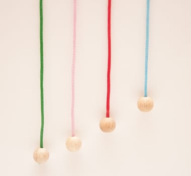 Hanging colour laces with wooden round tips