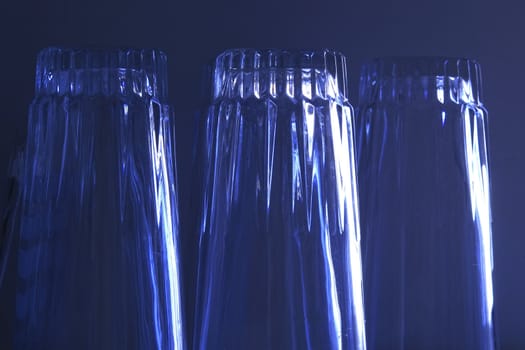 three upside down glasses with blue overlay