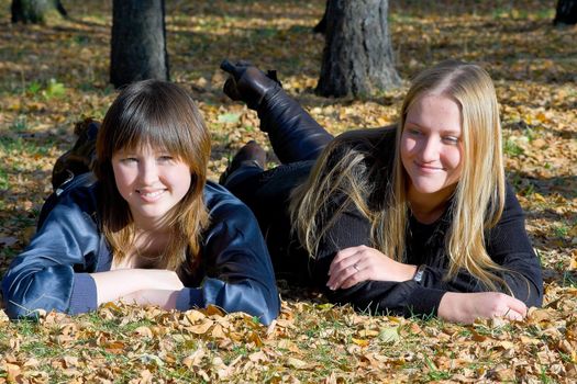 Two girlfriends against the autumn nature