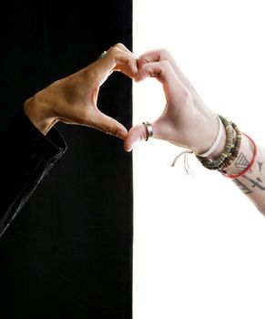 Close up of black and white hands making a heart