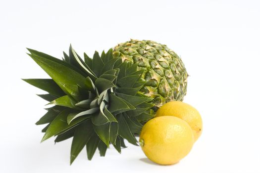 Fresh ananas and lemons isolated on white background.