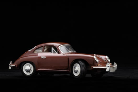 Toy car. Black background.