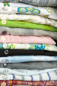 stack of colored shirt, front view, details of buttons