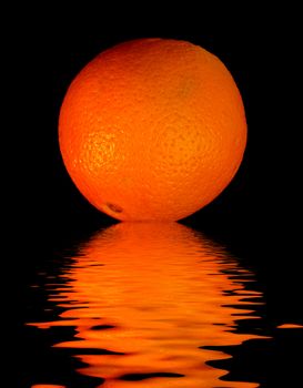 colored orange -  on black with reflection in water