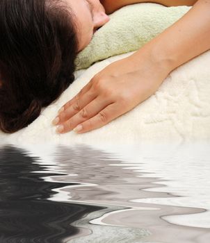 concept of spa - female laying over towels