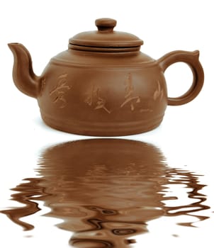 classic chinese teapot of brown clayand reflection in water