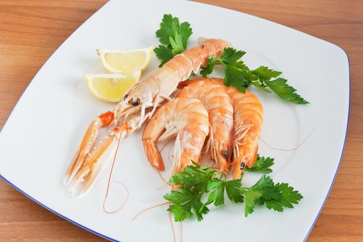 prawn and shrimps with lemon and parsley on a white plate