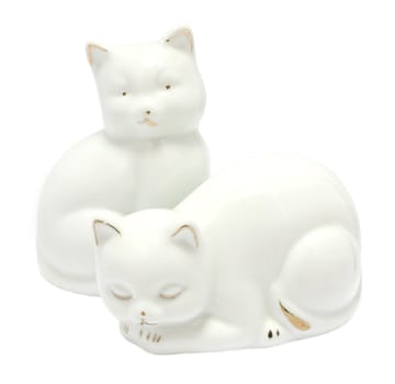 Kitsch white porcelain kitten figurines isolated on white background
