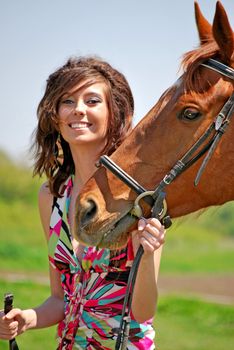 young and attractive woman riding brown horse