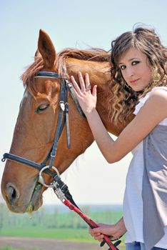 young and attractive woman riding brown horse