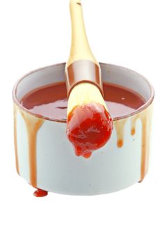 Barbecue sauce and basting brush isolated on white.