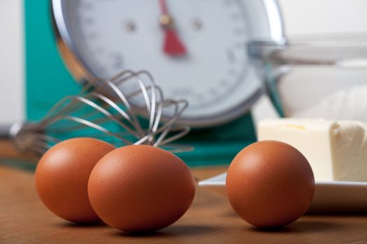 eggs and a eggbeater on a wooden table