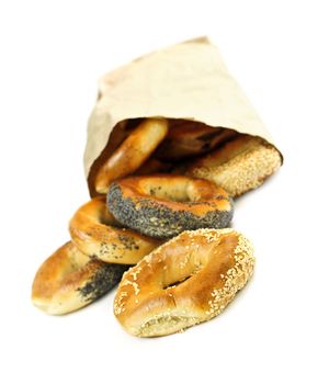Fresh Montreal style bagels in paper bag on white background
