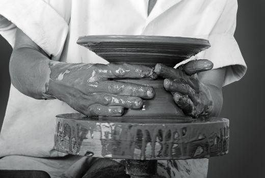 Close-up picture of a potter works a potter's wheel