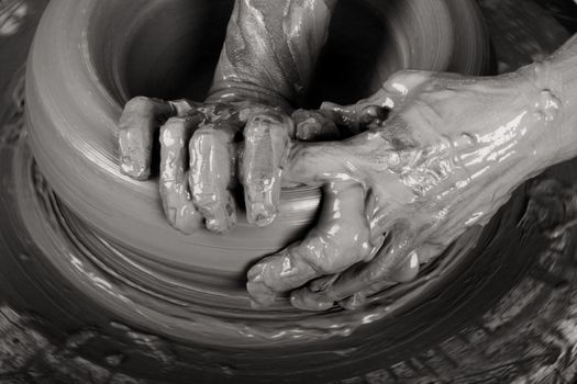 Close-up picture of a potter works a potter's wheel