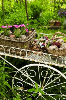 Flower cart with two baskets in summer garden