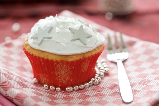 Delicious winter cupcake with icing and little sugar stars
