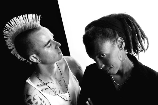 Portrait of white man with mohawk and black woman with dreadlocks