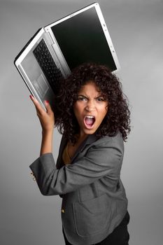 Angry woman throwing laptop