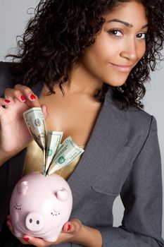 Black woman holding piggy bank money