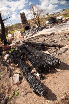 Remains of a Burned Down House with Brick Fireplace Standing.