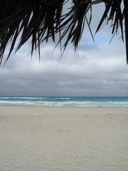 turquoise tropical ocean and dark blue sky