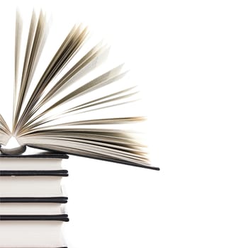 pile of books with one book open on white background 