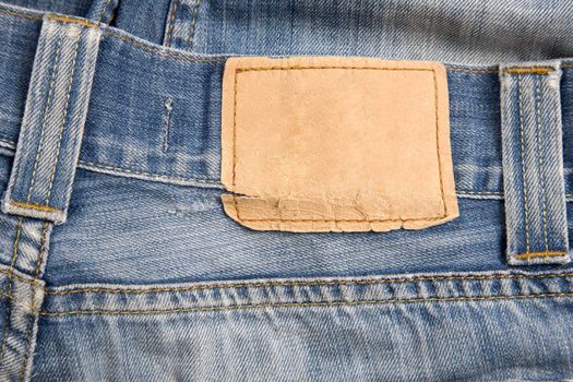 front view of denim label, blue jeans and leather label