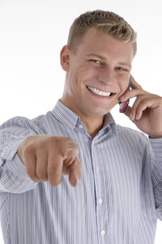 pointing man talking on mobile on an isolated white background
