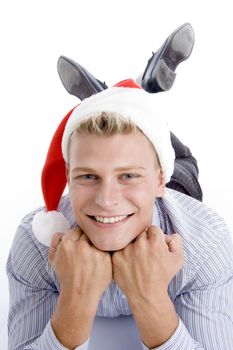 happy laying man with christmas hat against white background