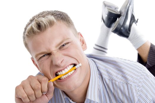 man holding pencil with teeth with white background