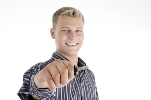 smiling handsome man holding key on an isolated white background