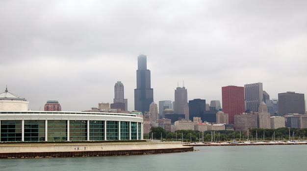 A picture of the Chicago skyline with the aquarium in the foreground