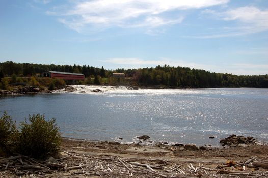 Landscape picture of a covered bridge over some rapids