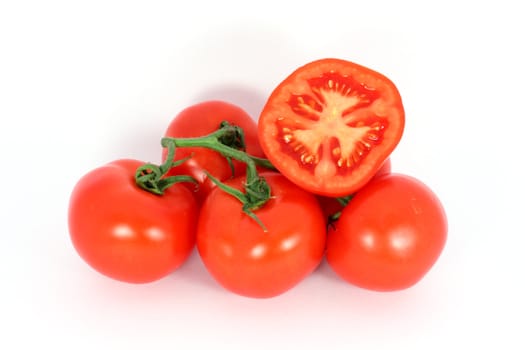 Red tomatoes on the branch isolated on white