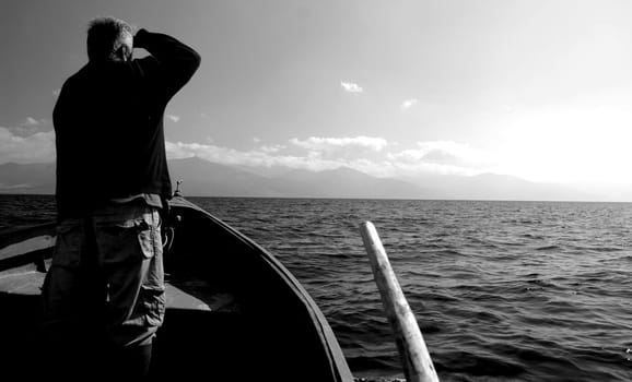 fisherman looking lake