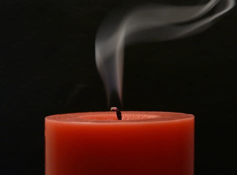 Candle with smoke on the black background