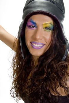 close up of smiling female model in a cap on an isolated white background