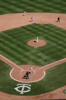 A twins pitcher stares down a Cleveland Indians batter at the brand new outdoor ballpark in Minneapolis