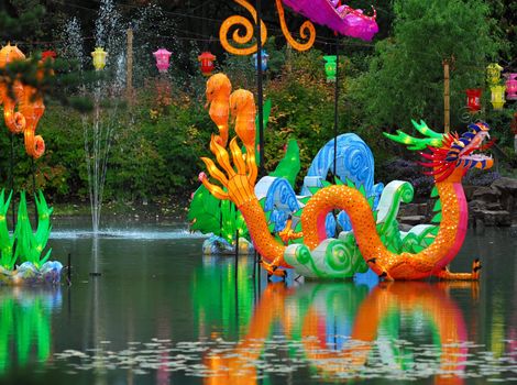 Portrait of an Illuminated Chinese Dragon on a lake 