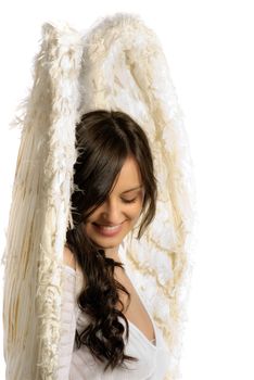 Young woman with angel wings smiling isolated on white