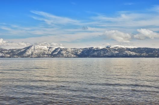 View on a lake Tahoe lit by afternoon sun in winter.