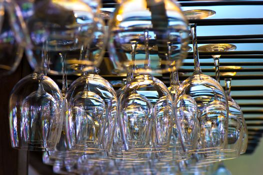 hanging wineglasses, selective focus, lot of color reflecions and chromatic aberrations left intentionally