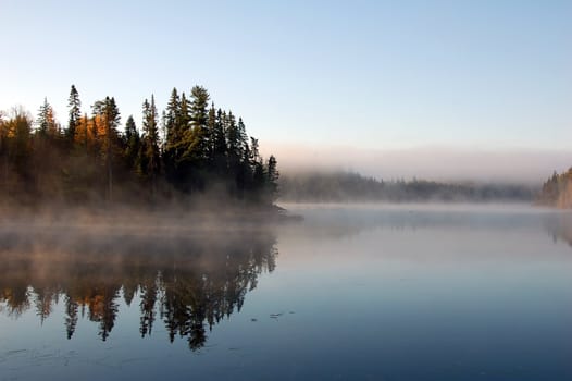 A beautiful autumn's landscape in the morning with fog and mist