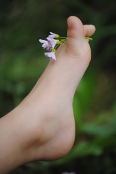 childs foot with flower
